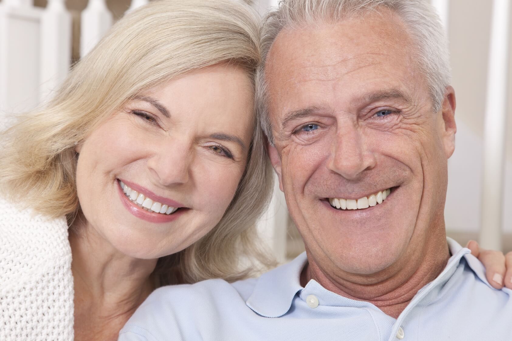 Smiling Mature Couple Touching Heads after all-on-4 dental implant procedure