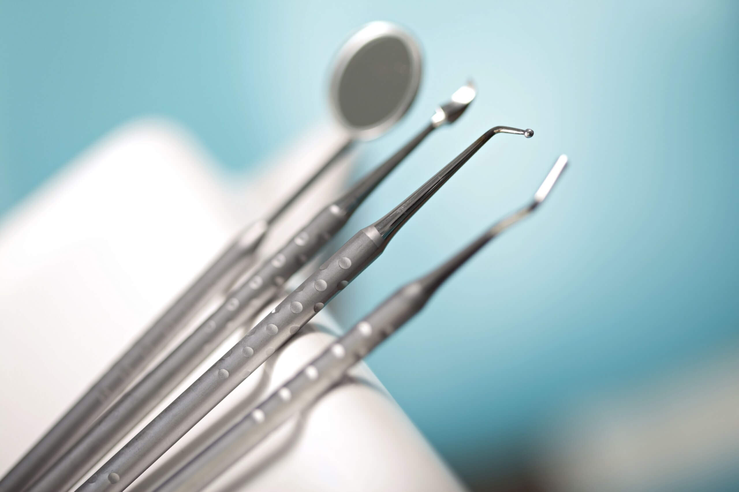 Blurred Dental Surgery Tools on Blue Background