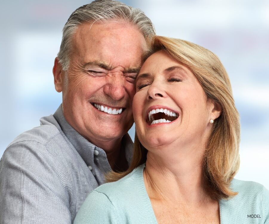 Older Couple Smiling and Embracing With Eyes Closed