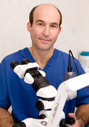 Dr. Scott Kissel In Lab Wearing Blue Scrubs